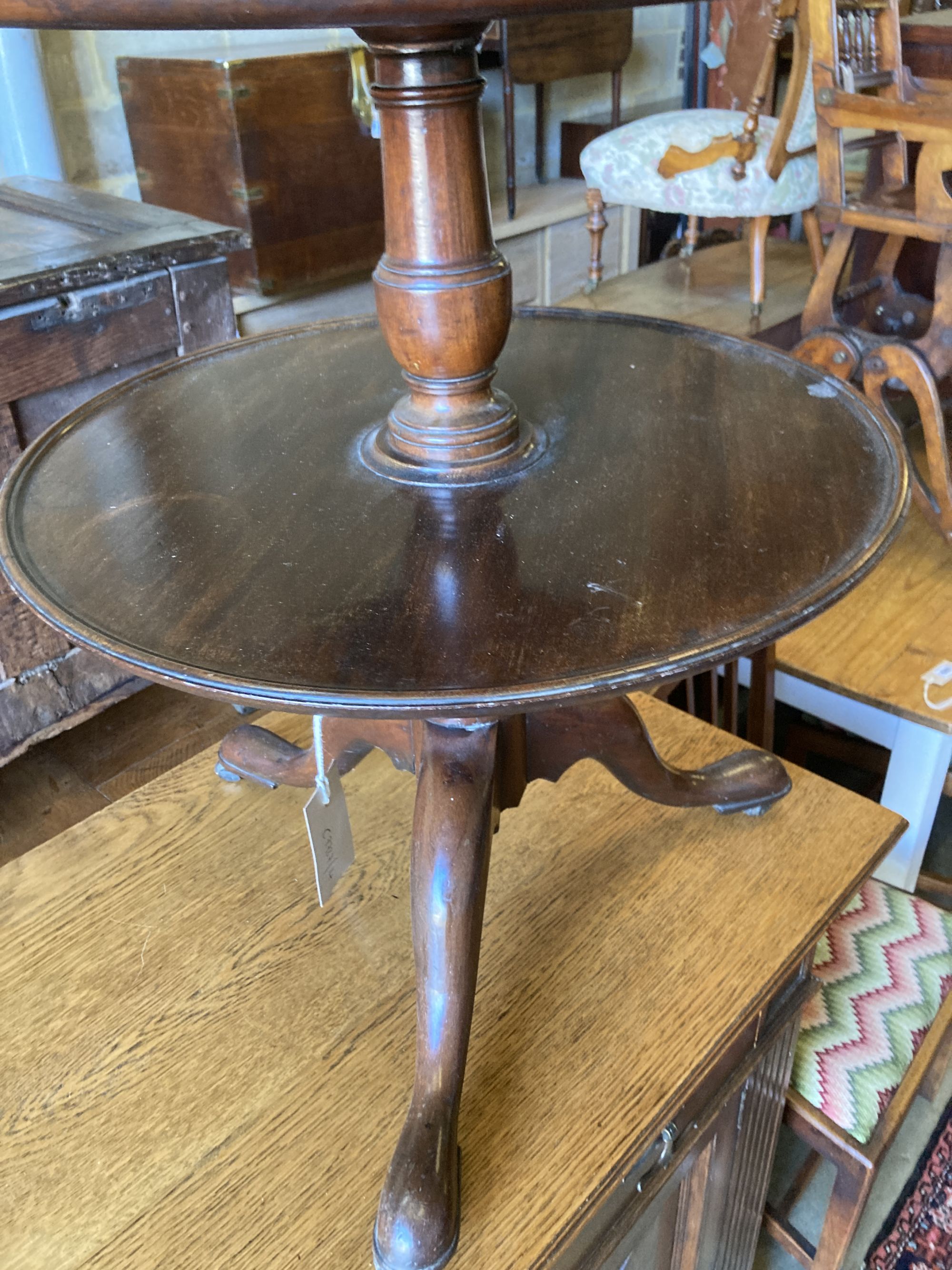 A 19th century mahogany three tier circular dumb waiter, with dish top on tripod base, height 106cm